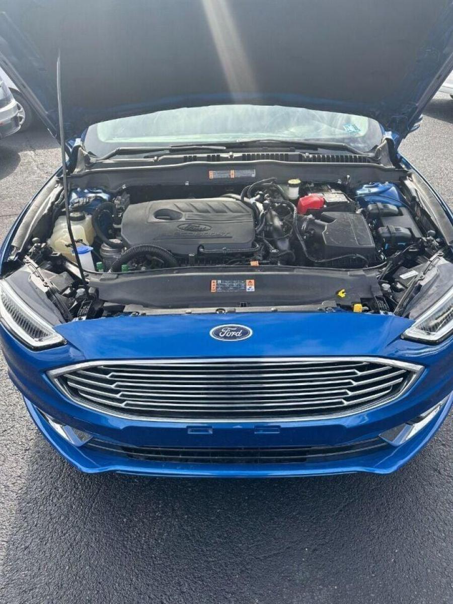 2017 Blue Ford Fusion (3FA6P0HD7HR) with an 1.5L I4 Turbocharger 1.5L I4 engine, located at 4845 Woodbury Pike, Roaring Springs, PA, (814) 317-5008, (814) 317-5008, 40.250935, -78.366959 - 2017 Ford Fusion SE, automatic, 26k, FWD, leather, big screen radio, heated seats, Navigation, power seats, power windows/locks, cruise/tile wheel, hands free phone, rear back up camera, parking aid. Vehicle is a Reconstructed title due to having a front bumper cover replaced due to deer damage. B - Photo #3