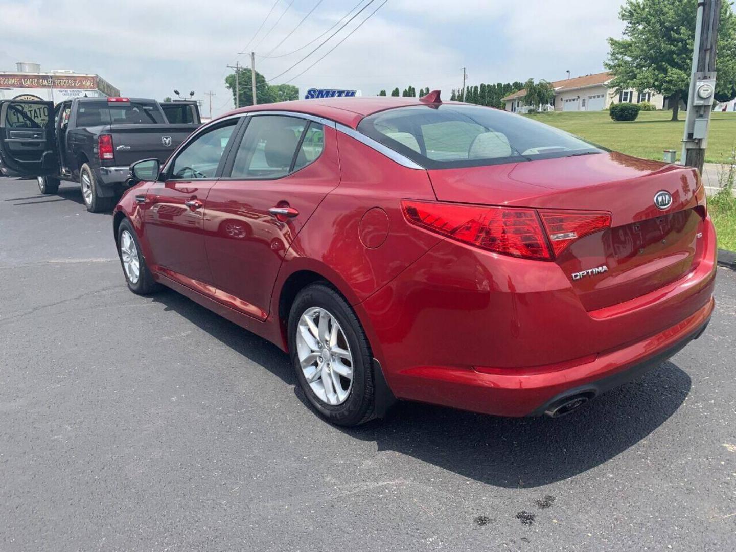 2013 Burgundy Kia Optima (5XXGM4A78DG) with an 2.4L I4 2.4L I4 engine, located at 4845 Woodbury Pike, Roaring Springs, PA, (814) 317-5008, (814) 317-5008, 40.250935, -78.366959 - 2013 Kia Optima, automatic, 80k original miles, power windows/locks, cruise/tilt wheel, air conditioning and more. Vehicle is being sold cheaper due to having a Reconstructed title from damage on rear deck lid and rear bumper cover. No paint work was done. The same color parts were bolted on. Cl - Photo#2