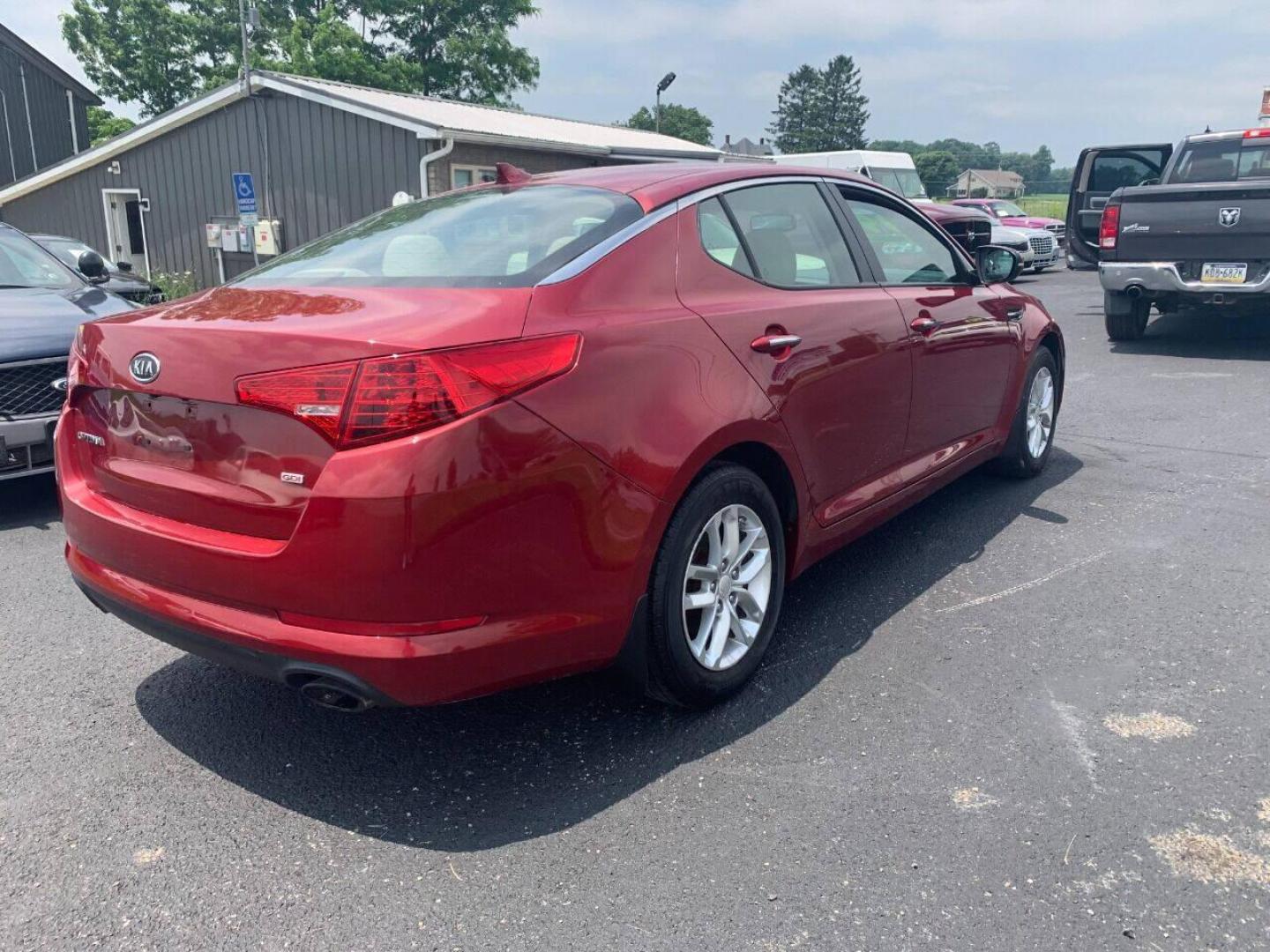 2013 Burgundy Kia Optima (5XXGM4A78DG) with an 2.4L I4 2.4L I4 engine, located at 4845 Woodbury Pike, Roaring Springs, PA, (814) 317-5008, (814) 317-5008, 40.250935, -78.366959 - 2013 Kia Optima, automatic, 80k original miles, power windows/locks, cruise/tilt wheel, air conditioning and more. Vehicle is being sold cheaper due to having a Reconstructed title from damage on rear deck lid and rear bumper cover. No paint work was done. The same color parts were bolted on. Cl - Photo#3