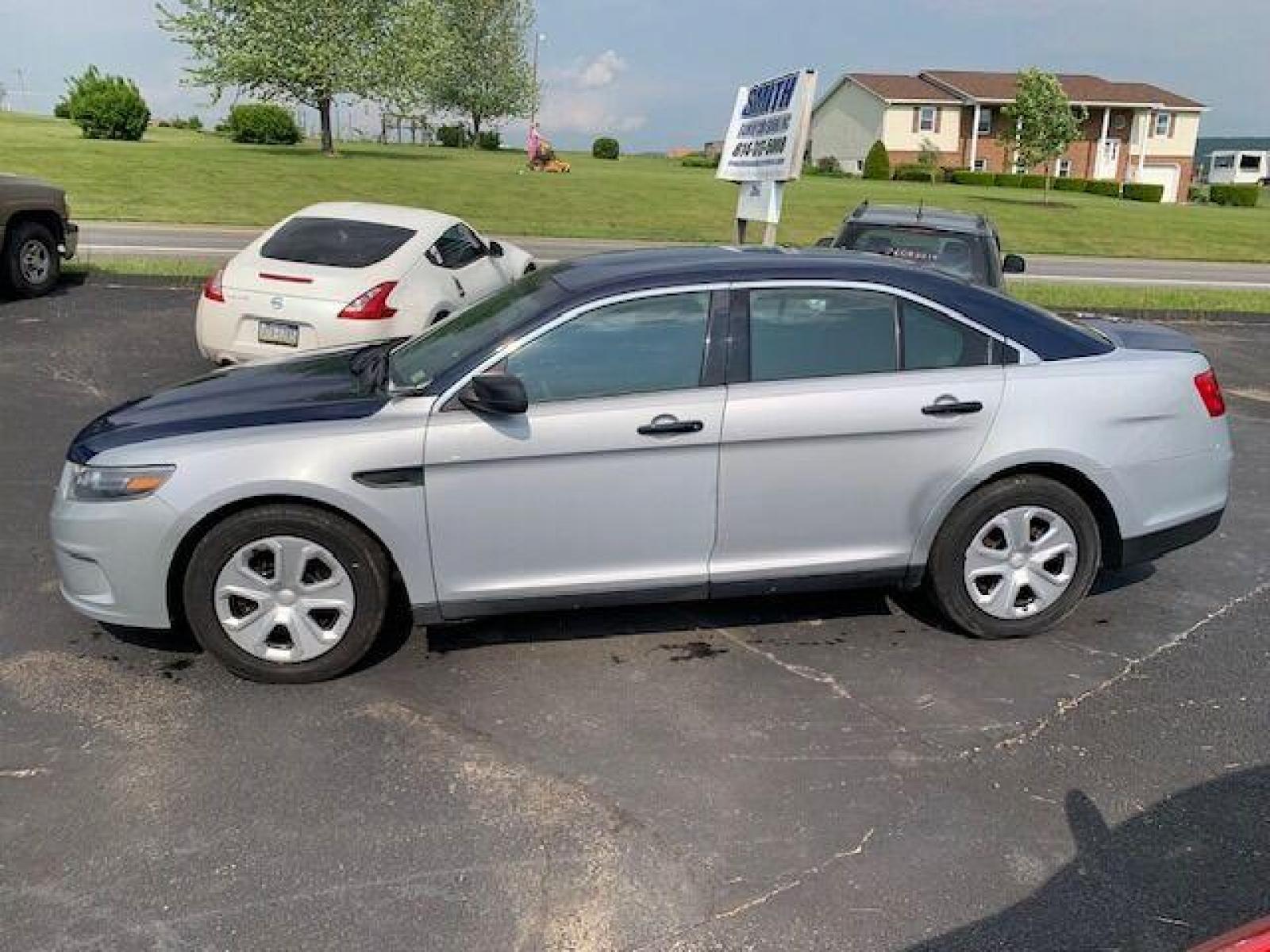 2016 Silver Ford Taurus (1FAHP2MK0GG) with an 3.7L V6 3.7L V6 engine, located at 4845 Woodbury Pike, Roaring Springs, PA, (814) 317-5008, (814) 317-5008, 40.250935, -78.366959 - Photo #1