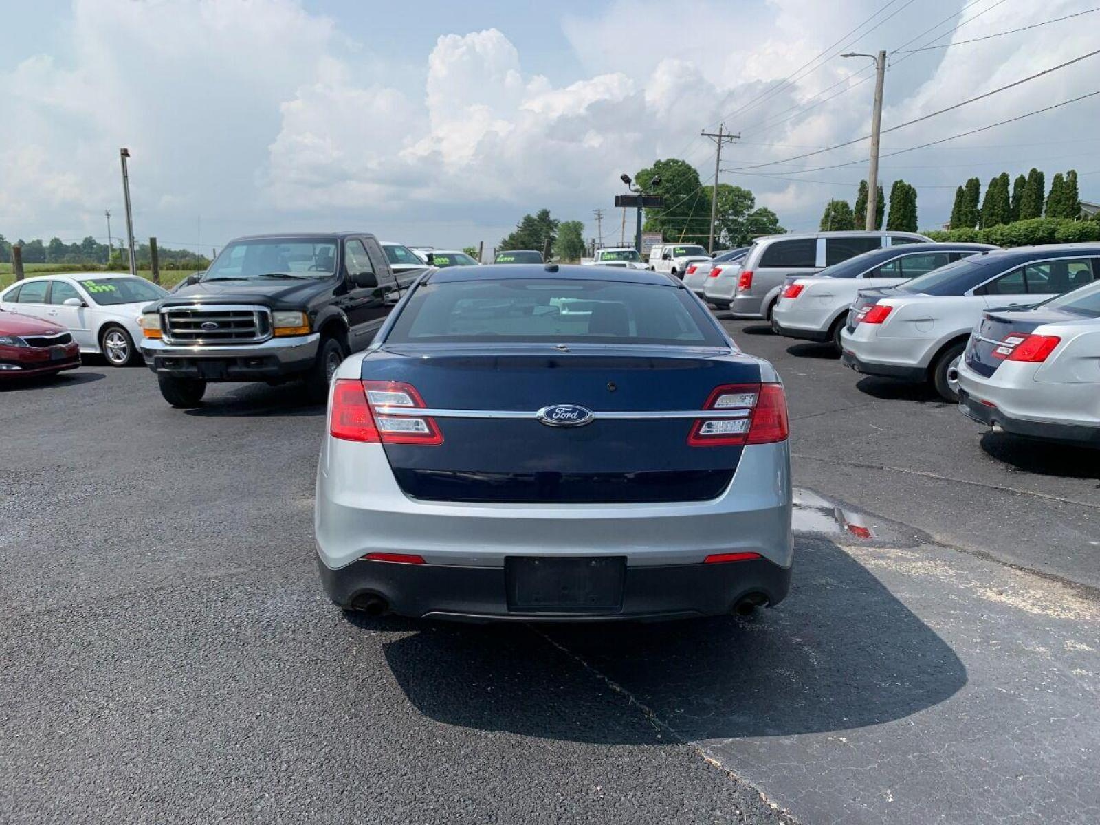 2016 Silver Ford Taurus (1FAHP2MKXGG) with an 3.7L V6 3.7L V6 engine, located at 4845 Woodbury Pike, Roaring Springs, PA, (814) 317-5008, (814) 317-5008, 40.250935, -78.366959 - Photo #2