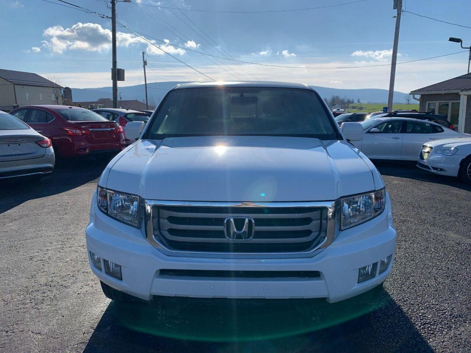 2014 White Honda Ridgeline (5FPYK1F54EB) with an 3.5L V6 3.5L V6 engine, located at 4845 Woodbury Pike, Roaring Springs, PA, (814) 317-5008, (814) 317-5008, 40.250935, -78.366959 - 2014 Honda Ridgeline, automatic, V6, 64k, 4x4, leather, roof, power windows/locks, cruise/tilt wheel, air conditioning, like new tires, new inspection and more. Rust free! Must see condition! Vehicle is only being sold cheaper due to having a Reconstructed title. Truck had damage to lower contr - Photo #2