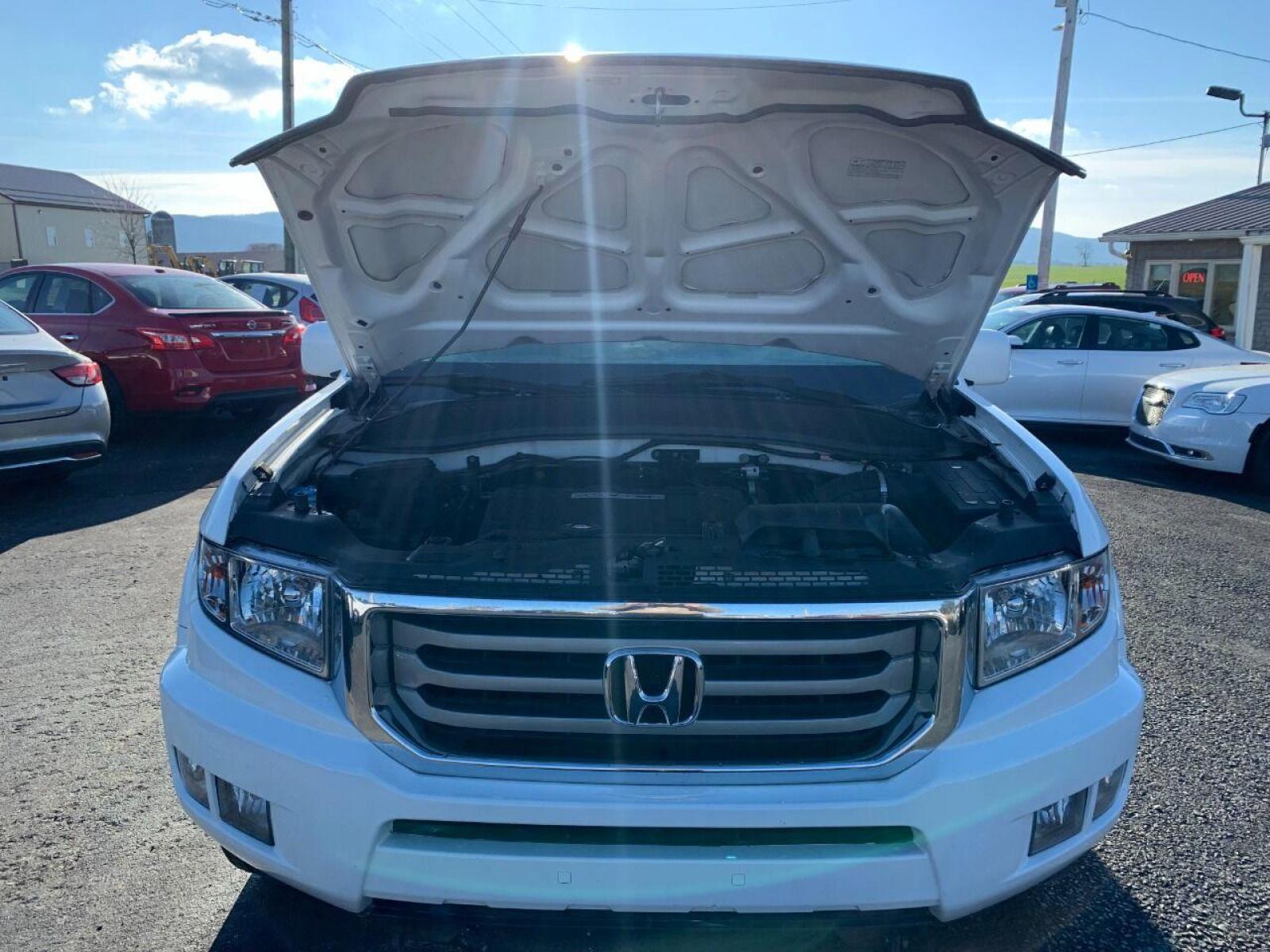 2014 White Honda Ridgeline (5FPYK1F54EB) with an 3.5L V6 3.5L V6 engine, located at 4845 Woodbury Pike, Roaring Springs, PA, (814) 317-5008, (814) 317-5008, 40.250935, -78.366959 - 2014 Honda Ridgeline, automatic, V6, 64k, 4x4, leather, roof, power windows/locks, cruise/tilt wheel, air conditioning, like new tires, new inspection and more. Rust free! Must see condition! Vehicle is only being sold cheaper due to having a Reconstructed title. Truck had damage to lower contr - Photo #8