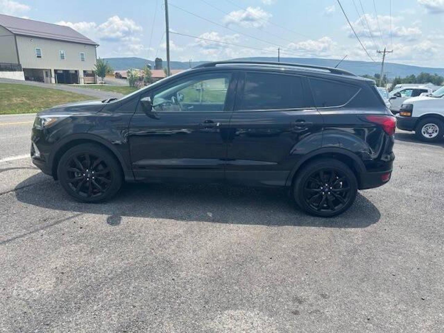 2019 Black Ford Escape (1FMCU9GDXKU) with an 1.5L I4 Turbocharger 1.5L I4 engine, located at 4845 Woodbury Pike, Roaring Springs, PA, (814) 317-5008, (814) 317-5008, 40.250935, -78.366959 - 2019 FORD ESCAPE AWD 1.5 L I4 TURBO ALL WHEEL DRIVE, BLACK OUT PACKAGE AUTOMATIC TRANSMISSION A/C ALL LEATHER AND HEATED SEATS.NAVIGATION POWER GATE POWER WINDOWS AND LOCKS SIRIUS RADIO.BACK UP CAMERA BLACK WHEELS BLUE TOOTH. NEW TIRES RUN GREAT NEW INSPECTION BEING SOLD AT LOWER COST BECAUSE IT IS - Photo#3