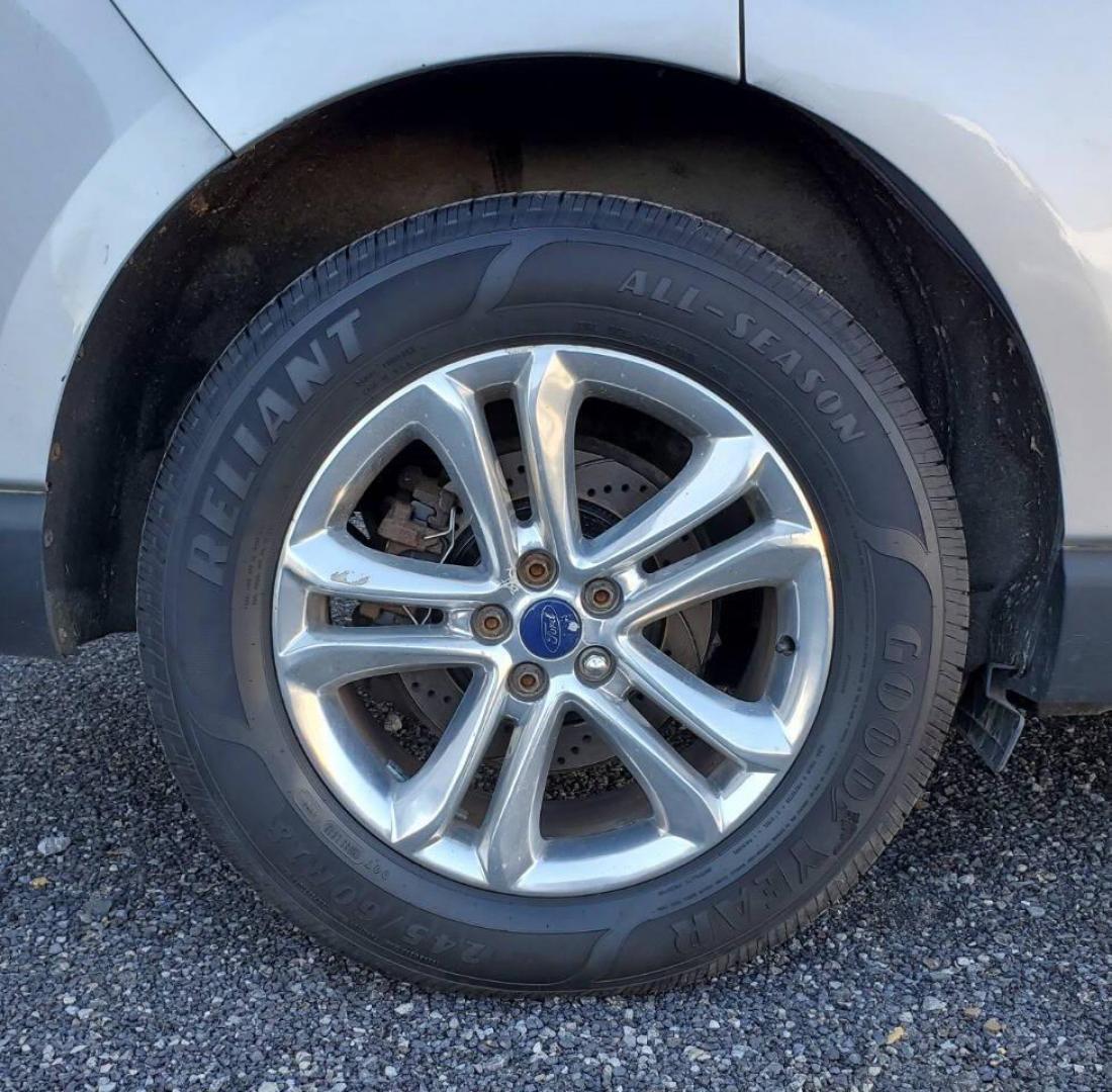 2015 Silver Ford Edge (2FMTK4J90FB) with an 2.0L I4 Turbocharger 2.0L I4 engine, located at 4845 Woodbury Pike, Roaring Springs, PA, (814) 317-5008, (814) 317-5008, 40.250935, -78.366959 - 2015 Ford Edge SEL AWD 4 dr Crossover 2.0L I4 Turbocharger 171k miles Fully serviced and ready to go! New brakes and rotors all around. Leather, Sirius XM, Single CD Player, Bluetooth, Back-up Camera, Heated Seats, Heated Side Mirrors, Moon Roof. Selling so cheap because it has an R-Title due to a h - Photo#6